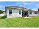 Well-manicured lawn, charming patio with seating, enhances outdoor enjoyment at 4296 Mirror Ct, Clermont, FL 34714