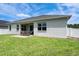 Spacious backyard features a well-maintained lawn and cozy patio seating area at 4296 Mirror Ct, Clermont, FL 34714