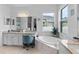 Spacious bathroom with a soaking tub, vanity with double sinks, and a makeup area illuminated by modern lighting at 4296 Mirror Ct, Clermont, FL 34714
