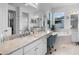 Bright bathroom showcasing a vanity with double sinks, soaking tub, and large mirror at 4296 Mirror Ct, Clermont, FL 34714