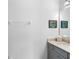 Simple bathroom with a granite vanity, mirror, and convenient towel rack for a clean and functional space at 4296 Mirror Ct, Clermont, FL 34714
