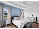 Spacious bedroom with tray ceiling, modern fan, and two windows for natural light at 4296 Mirror Ct, Clermont, FL 34714