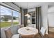 Bright dining area boasts large windows and neutral decor to maximize natural light at 4296 Mirror Ct, Clermont, FL 34714