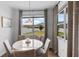 Bright dining area boasts large windows and neutral decor to maximize natural light at 4296 Mirror Ct, Clermont, FL 34714