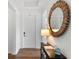 Bright entryway featuring wood floors, a stylish mirror, and a sleek console table, creating a welcoming atmosphere at 4296 Mirror Ct, Clermont, FL 34714