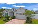 Beautiful single-Gathering home featuring a brick driveway, manicured landscaping, and a convenient two-car garage at 4296 Mirror Ct, Clermont, FL 34714