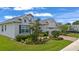 Lovely home showcasing lush landscaping, a brick driveway, and an attached two-car garage in a serene neighborhood at 4296 Mirror Ct, Clermont, FL 34714