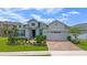 Charming single-Gathering home showcasing a brick driveway, meticulously maintained landscaping, and an attached two-car garage at 4296 Mirror Ct, Clermont, FL 34714