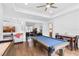 Spacious game room with pool table, adjacent to living room and office space at 4296 Mirror Ct, Clermont, FL 34714