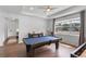 Game room featuring a pool table, wood floors, a table with chairs, and a large window at 4296 Mirror Ct, Clermont, FL 34714