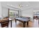 A game room features a pool table, a shuffleboard table, recessed lights, and a ceiling fan at 4296 Mirror Ct, Clermont, FL 34714