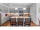 Modern kitchen featuring a large island with seating and stainless steel appliances at 4296 Mirror Ct, Clermont, FL 34714