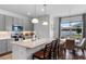 Modern kitchen with granite counters, island, and stainless steel appliances adjacent to dining area at 4296 Mirror Ct, Clermont, FL 34714