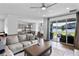 Open-concept living room featuring modern finishes and seamless flow to the outdoor patio at 4296 Mirror Ct, Clermont, FL 34714