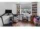 Bright office space with custom built-in shelving and a large window overlooking the neighborhood at 4296 Mirror Ct, Clermont, FL 34714