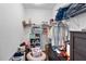 Organized walk-in closet with shelving, hanging rods, and storage bins for optimal space utilization at 4296 Mirror Ct, Clermont, FL 34714