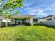 Outdoor living featuring a covered patio with furniture, a barbecue, and a well-manicured lawn at 4336 Foggy Oak Ln, Sanford, FL 32773
