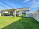 Backyard offers a covered patio, lush green lawn, and well-maintained landscaping, perfect for outdoor living at 4336 Foggy Oak Ln, Sanford, FL 32773