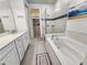 This primary bathroom features a double vanity, walk-in closet, glass enclosed shower, and soaking tub at 4336 Foggy Oak Ln, Sanford, FL 32773