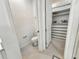 This bathroom has a toilet, sink and access to a walk-in closet with custom shelving at 4336 Foggy Oak Ln, Sanford, FL 32773