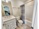 Bright bathroom features a vanity with sink and a shower-tub combination with patterned shower curtain at 4336 Foggy Oak Ln, Sanford, FL 32773
