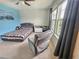 Comfortable bedroom with a view to the window and cozy chair at 4336 Foggy Oak Ln, Sanford, FL 32773