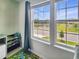 Bright and airy bedroom boasts a large double-paned window with lake views at 4336 Foggy Oak Ln, Sanford, FL 32773