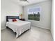 Bright bedroom with a queen bed, ceiling fan, and large window offering natural light at 4336 Foggy Oak Ln, Sanford, FL 32773