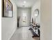 Inviting home entryway with decorative console table, mirror, and tile flooring at 4336 Foggy Oak Ln, Sanford, FL 32773