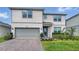 Charming two-story home with a manicured lawn, beautiful landscaping and gray siding at 4336 Foggy Oak Ln, Sanford, FL 32773