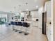 Open kitchen features a center island with bar seating, stainless steel appliances, and easy access to backyard patio at 4336 Foggy Oak Ln, Sanford, FL 32773