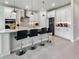 Bright kitchen featuring modern island with pendant lights, stainless appliances, and stylish bar stools at 4336 Foggy Oak Ln, Sanford, FL 32773