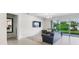 Comfortable living room featuring a plush sofa, TV, and sliding glass doors leading to a well-maintained backyard at 4336 Foggy Oak Ln, Sanford, FL 32773
