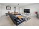 Bright living room featuring a large, comfortable sofa, a modern entertainment center, and plenty of natural light at 4336 Foggy Oak Ln, Sanford, FL 32773
