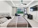 This main bedroom features a ceiling fan, workspace, TV, and comfortable reading chair at 4336 Foggy Oak Ln, Sanford, FL 32773