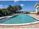 Community pool featuring crystal clear water, lounge chairs, and well-maintained grounds for relaxation and recreation at 4336 Foggy Oak Ln, Sanford, FL 32773