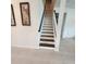 Clean staircase with white risers and dark wood treads, illuminated by natural light at 4336 Foggy Oak Ln, Sanford, FL 32773