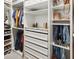 A large walk-in closet features custom shelving, drawers, and hanging racks for maximum storage space at 4336 Foggy Oak Ln, Sanford, FL 32773