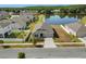Aerial view of home with well-kept lawn, landscaping, and pond access at 4350 Verde Valley Ln, Kissimmee, FL 34746
