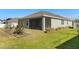 Well-maintained backyard showcasing a screened patio and verdant lawn at 4350 Verde Valley Ln, Kissimmee, FL 34746