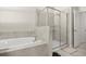 Bathroom features a soaking tub with tiled surround and a glass-enclosed shower, offering a spa-like experience at 4350 Verde Valley Ln, Kissimmee, FL 34746