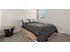 Simple bedroom features a bed with a black and white comforter, a side table, and a window for natural light at 4350 Verde Valley Ln, Kissimmee, FL 34746