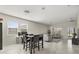 Bright dining area featuring a modern high-top table with views of the living room and lots of light at 4350 Verde Valley Ln, Kissimmee, FL 34746