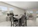 Bright dining area featuring a modern high-top table with views of the living room and lots of light at 4350 Verde Valley Ln, Kissimmee, FL 34746