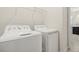 Well-lit laundry room featuring a white washer and dryer and wire shelving at 4350 Verde Valley Ln, Kissimmee, FL 34746
