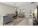 Inviting living room features neutral paint, tile floors, modern furniture and lots of natural light at 4350 Verde Valley Ln, Kissimmee, FL 34746
