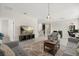 Bright open-concept living room showcasing modern furniture, tile flooring, and seamlessly connects to kitchen at 4350 Verde Valley Ln, Kissimmee, FL 34746