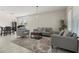 Spacious living area with tile flooring, modern decor, and a cozy seating arrangement at 4350 Verde Valley Ln, Kissimmee, FL 34746