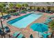 Community pool featuring lounge chairs, palm trees, and a splash pad at 4350 Verde Valley Ln, Kissimmee, FL 34746