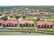 A full community aerial shot with waterfront property, and red tiled roofs, situated with manicured landscaping and ample parking at 446 Bouchelle Dr # 103, New Smyrna Beach, FL 32169